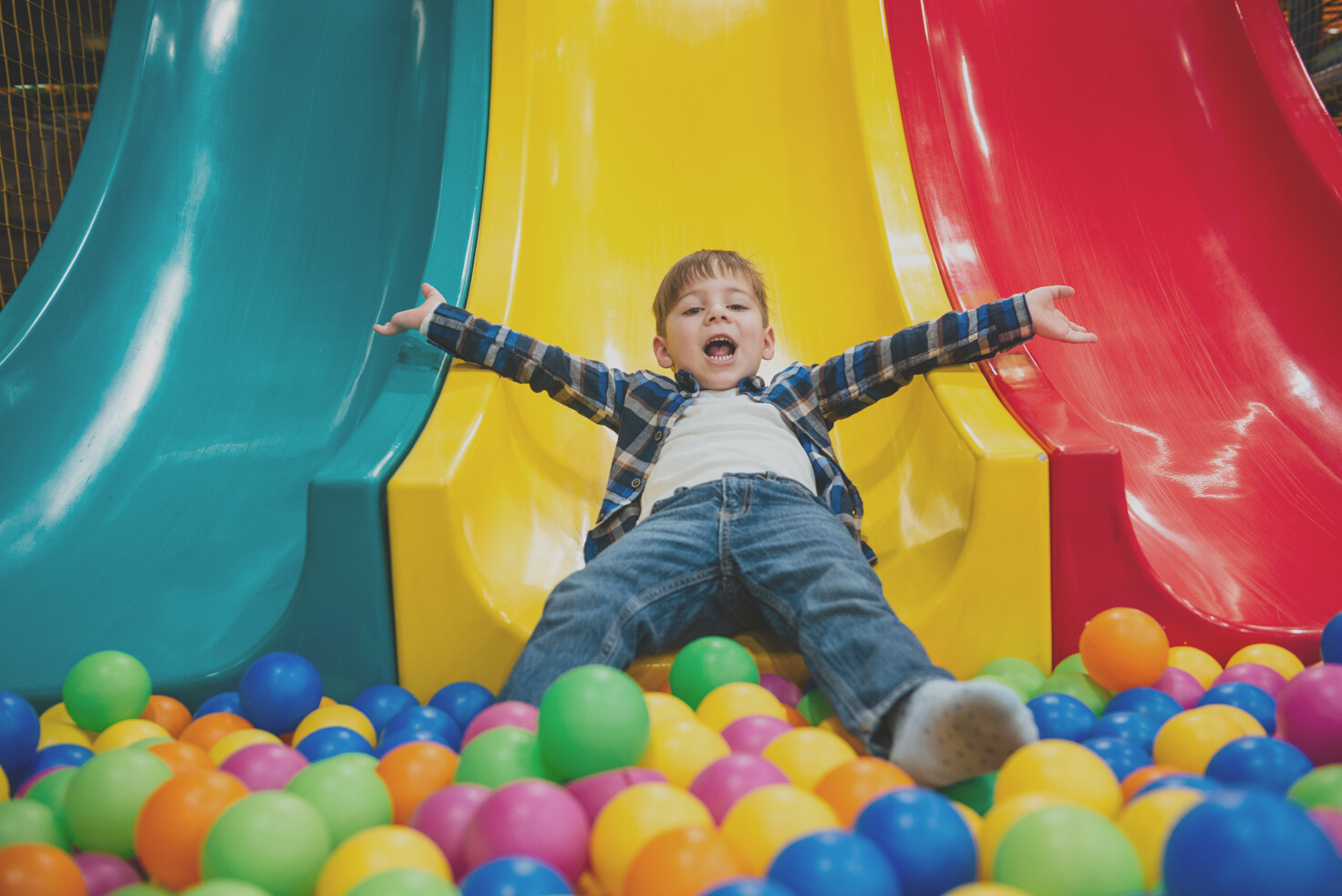  Boy Playing on Slide and Pool with Colorful Balls